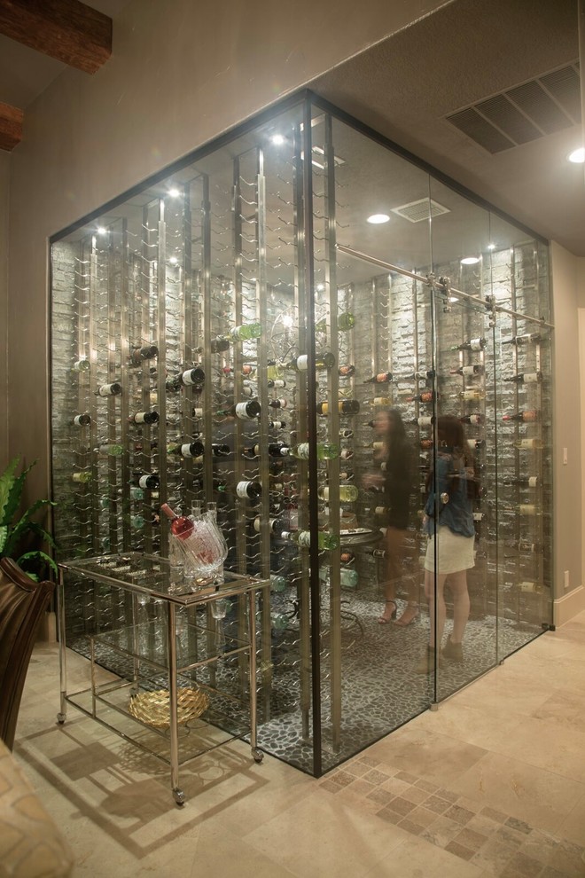 Large modern wine cellar in Austin with ceramic floors and display racks.