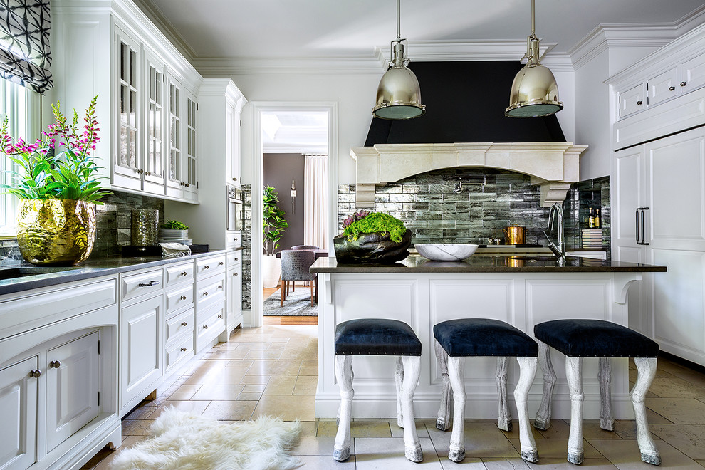 This is an example of a transitional u-shaped separate kitchen in Chicago with an undermount sink, raised-panel cabinets, white cabinets, black splashback, stone tile splashback, with island and beige floor.