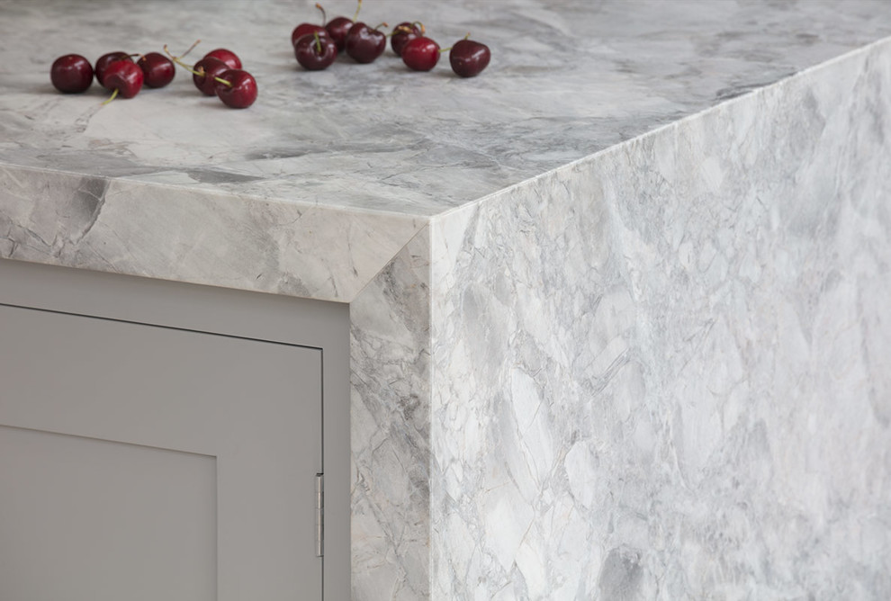 Design ideas for a large contemporary single-wall open plan kitchen in London with a submerged sink, marble worktops, white splashback, cement tile splashback, light hardwood flooring, an island, beige floors and grey worktops.