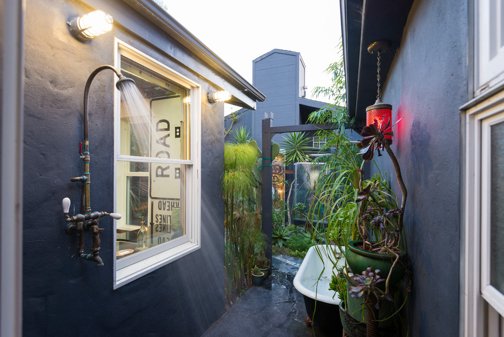 This is an example of an eclectic courtyard patio in San Francisco with no cover and an outdoor shower.
