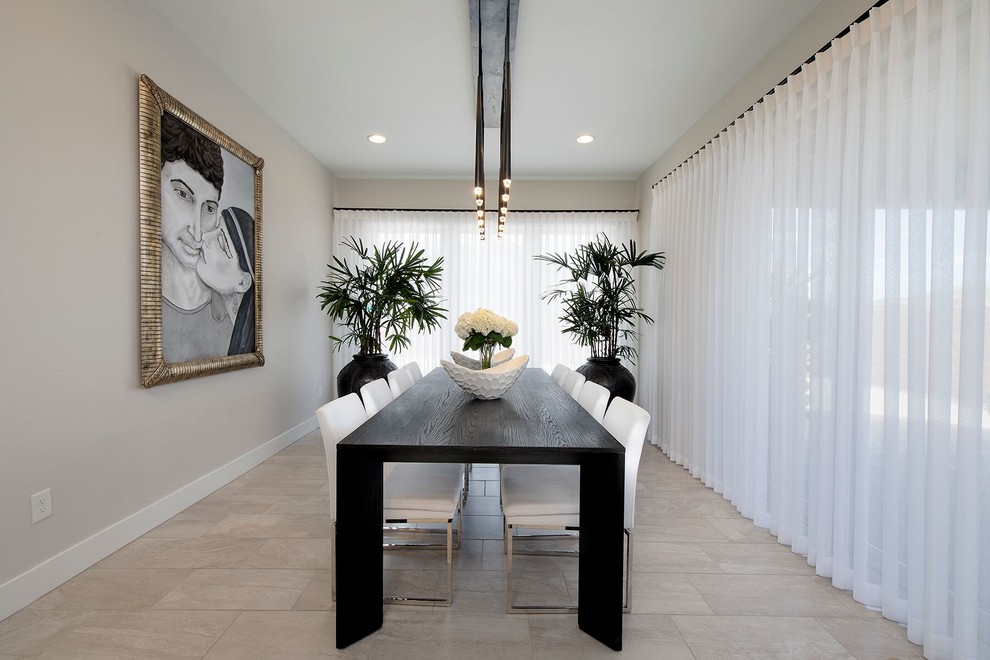 Photo of a contemporary separate dining room in Las Vegas with beige walls and beige floor.