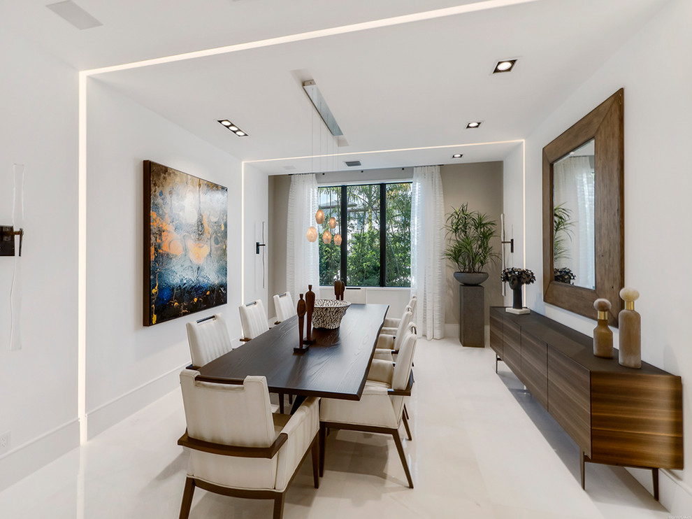 This is an example of a mid-sized contemporary separate dining room in Miami with white walls, no fireplace and marble floors.
