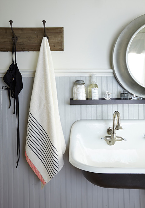 Beach style bathroom in Other with grey walls and a wall-mount sink.