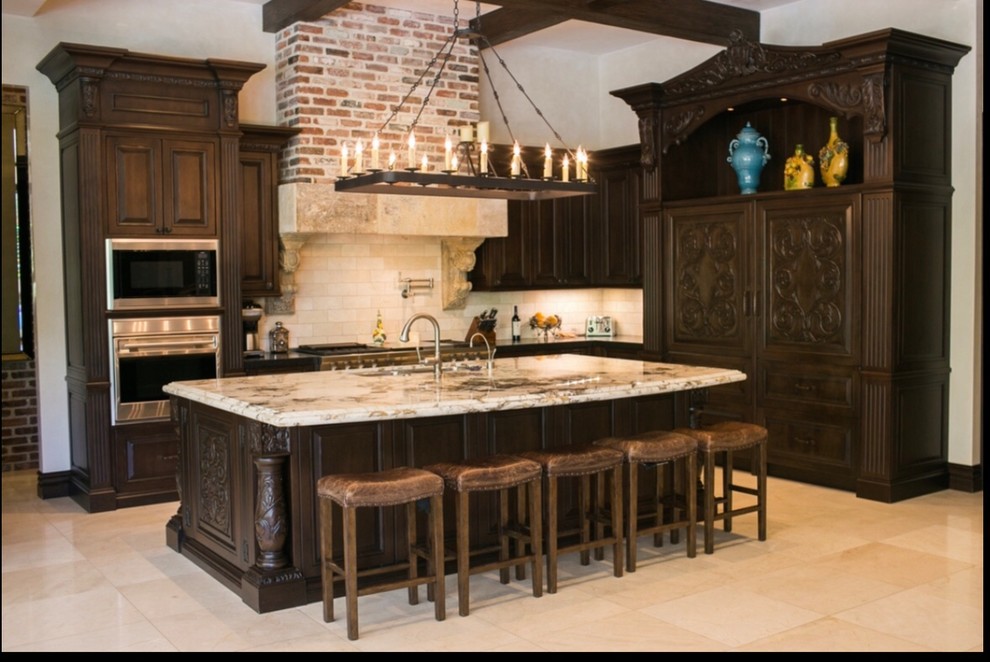 Mediterranean eat-in kitchen in Las Vegas with brown cabinets, white splashback, with island and exposed beam.