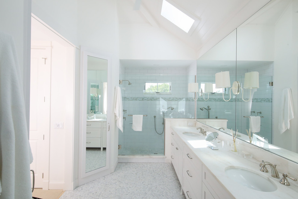 Transitional master bathroom in Miami with shaker cabinets, white cabinets, white tile, subway tile, mosaic tile floors, an undermount sink, marble benchtops, grey floor and a hinged shower door.
