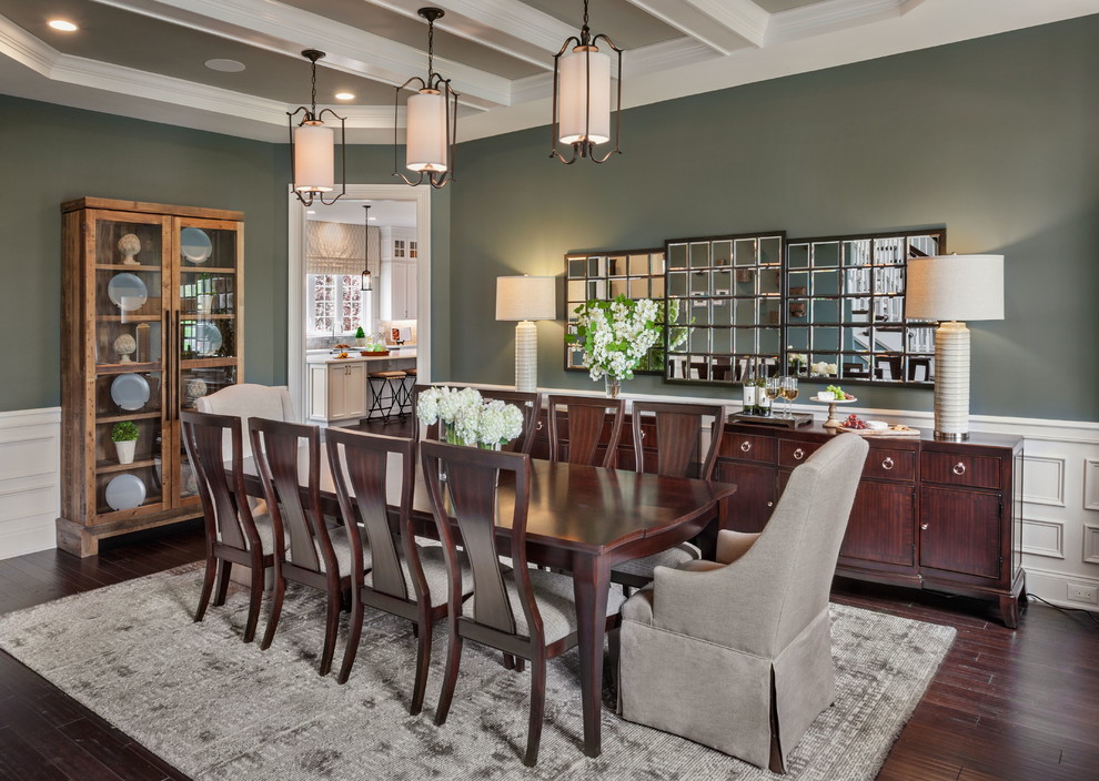 Transitional dining room in New York with green walls, dark hardwood floors and no fireplace.