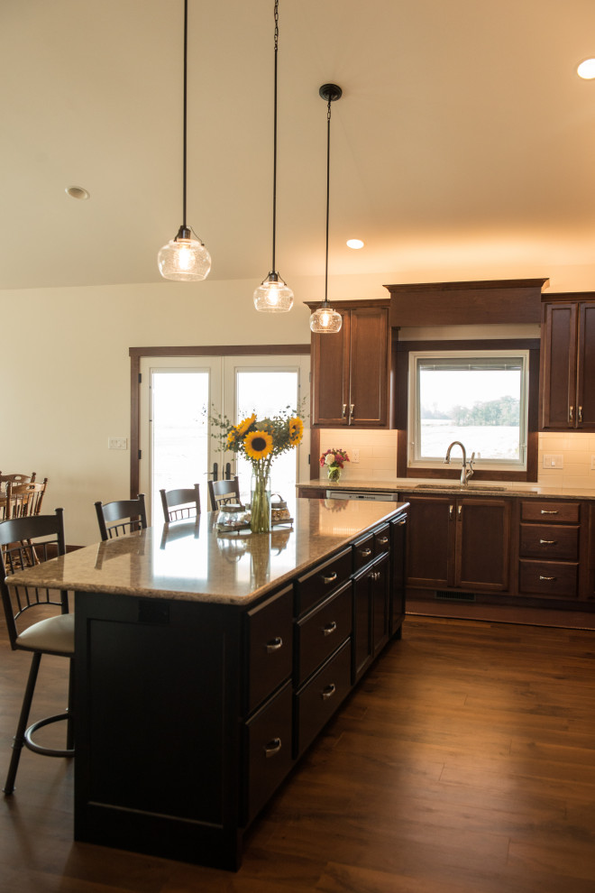 Example of a large transitional l-shaped medium tone wood floor open concept kitchen design with an undermount sink, flat-panel cabinets, medium tone wood cabinets, quartz countertops, white backsplash, ceramic backsplash, stainless steel appliances, an island and multicolored countertops
