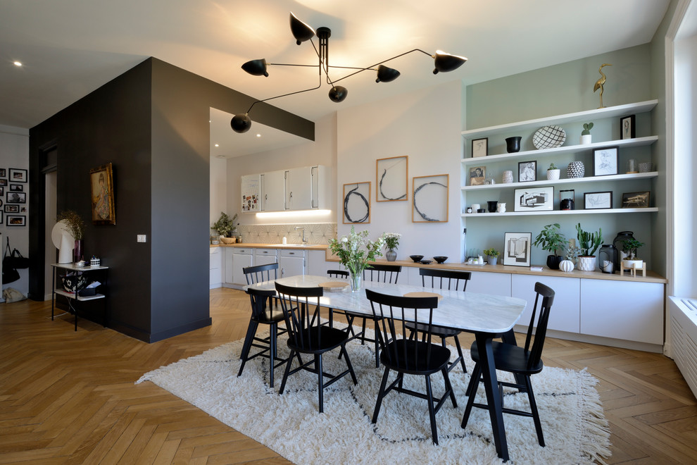 Photo of a scandinavian open plan dining in Lyon with multi-coloured walls, medium hardwood floors, no fireplace and brown floor.
