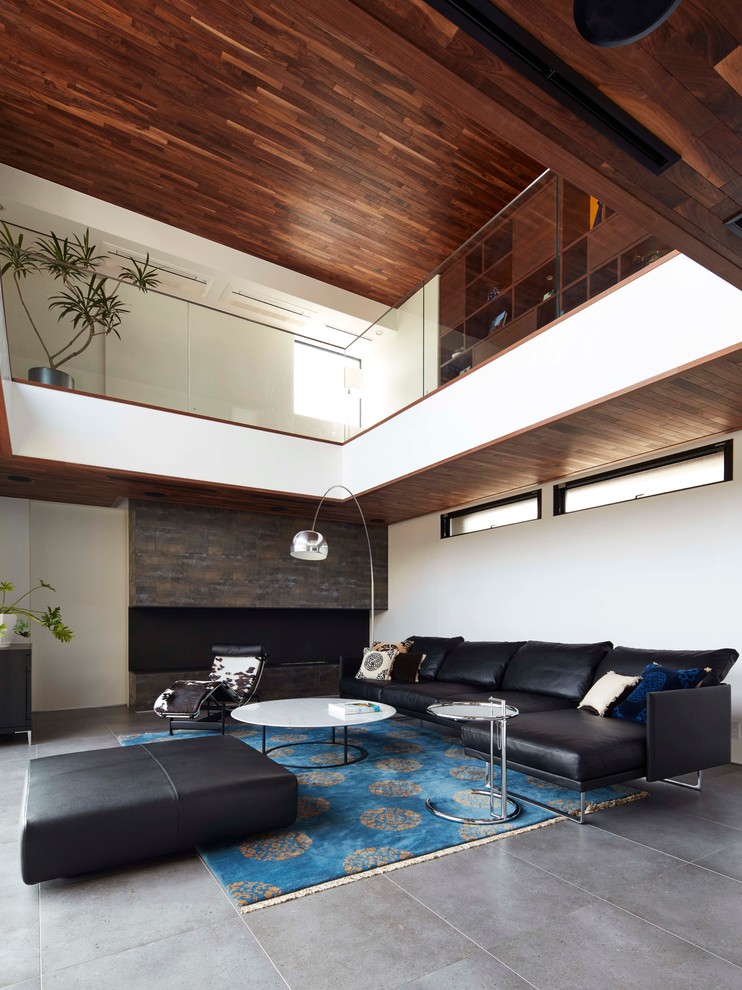 This is an example of a mid-sized contemporary enclosed living room in Tokyo Suburbs with white walls and slate floors.