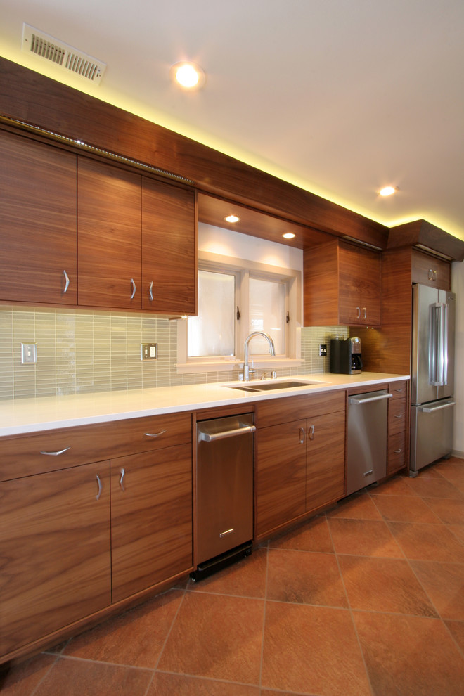 Large midcentury galley eat-in kitchen in Milwaukee with an undermount sink, flat-panel cabinets, medium wood cabinets, quartz benchtops, grey splashback, glass tile splashback, stainless steel appliances, ceramic floors and no island.