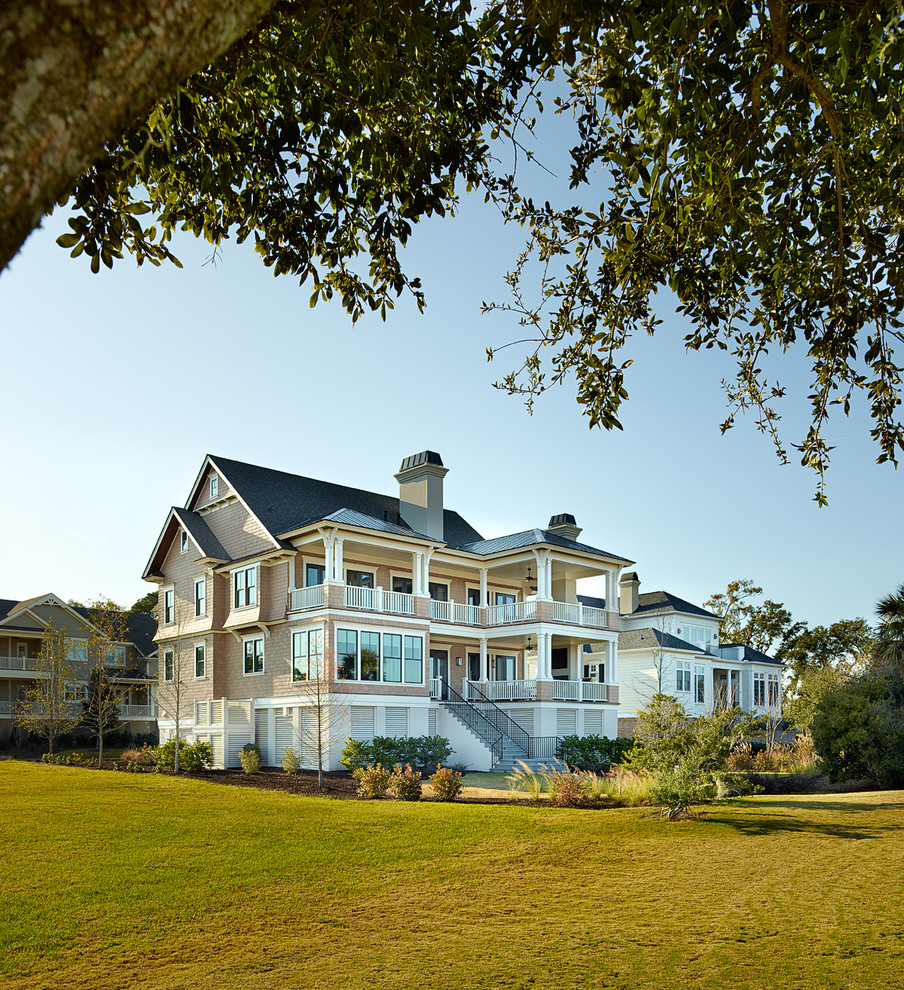Beach style two-storey exterior in Charleston with wood siding.