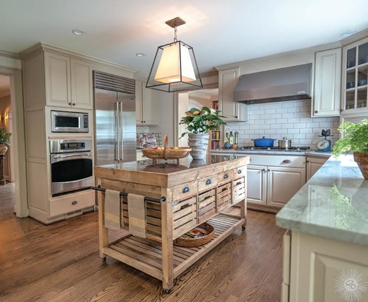 Inspiration for a large transitional u-shaped laminate floor and brown floor enclosed kitchen remodel in New York with raised-panel cabinets, white cabinets, quartzite countertops, white backsplash, subway tile backsplash, stainless steel appliances and an island