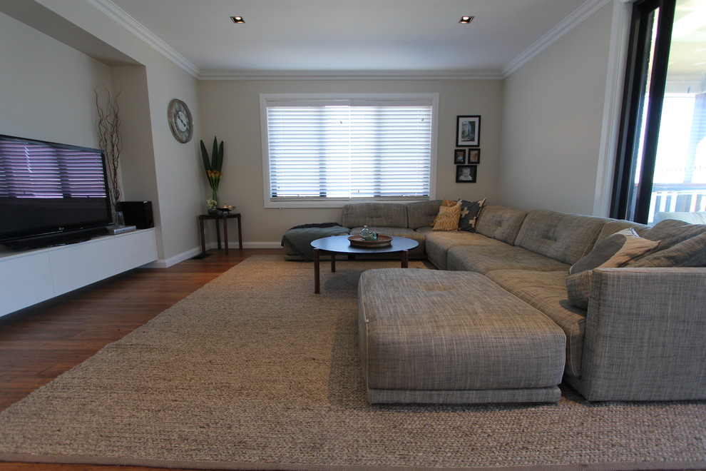 Inspiration for a mid-sized contemporary open concept living room in Canberra - Queanbeyan with grey walls, medium hardwood floors, no fireplace and a freestanding tv.