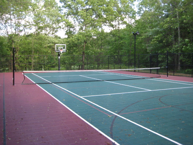 Large traditional backyard partial sun outdoor sport court in Boston with with outdoor playset and concrete pavers.