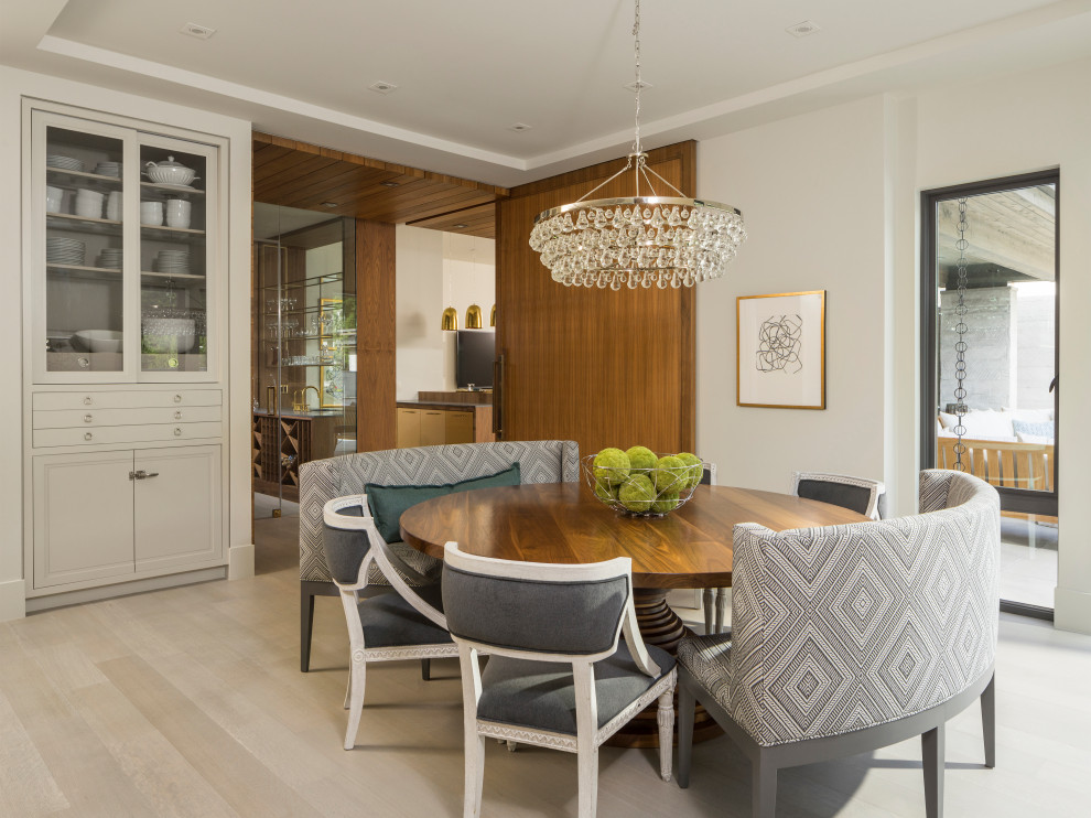 This is an example of a contemporary dining room in Salt Lake City with white walls, light hardwood floors and beige floor.