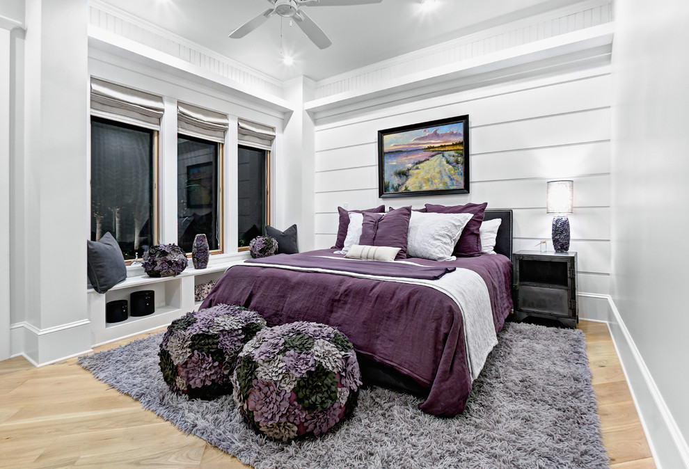 Beach style bedroom in Jacksonville with white walls, light hardwood floors and no fireplace.