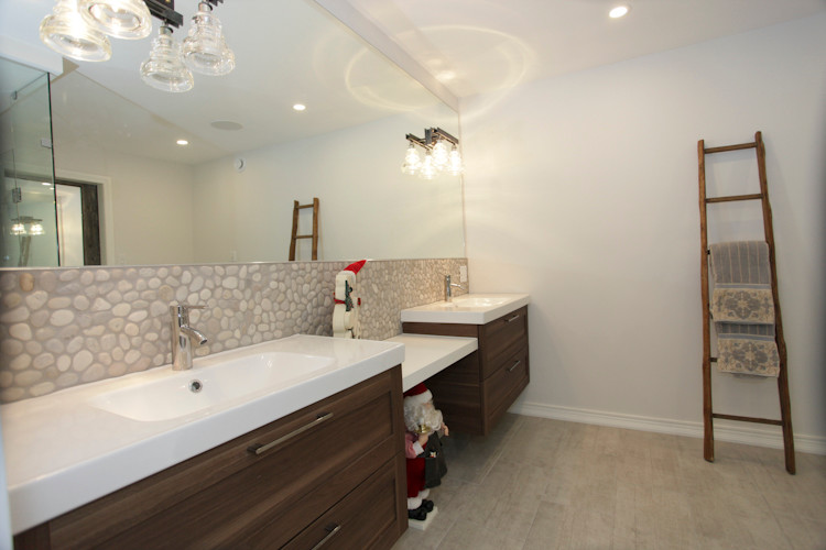 Inspiration for a mid-sized country kids bathroom in Toronto with flat-panel cabinets, dark wood cabinets, an alcove shower, a one-piece toilet, white tile, subway tile, white walls, a trough sink and engineered quartz benchtops.