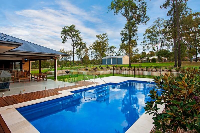 This is an example of a large contemporary backyard rectangular natural pool in Melbourne with decking.