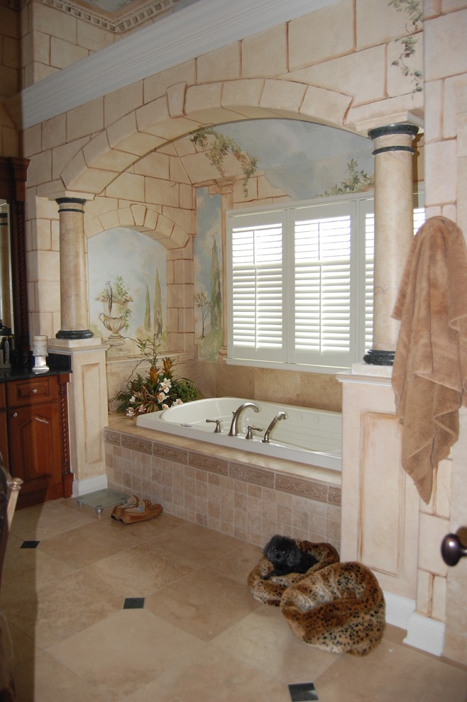 Inspiration for a mid-sized traditional master bathroom in Chicago with raised-panel cabinets, dark wood cabinets, an alcove tub, beige tile, limestone, multi-coloured walls, limestone floors and beige floor.