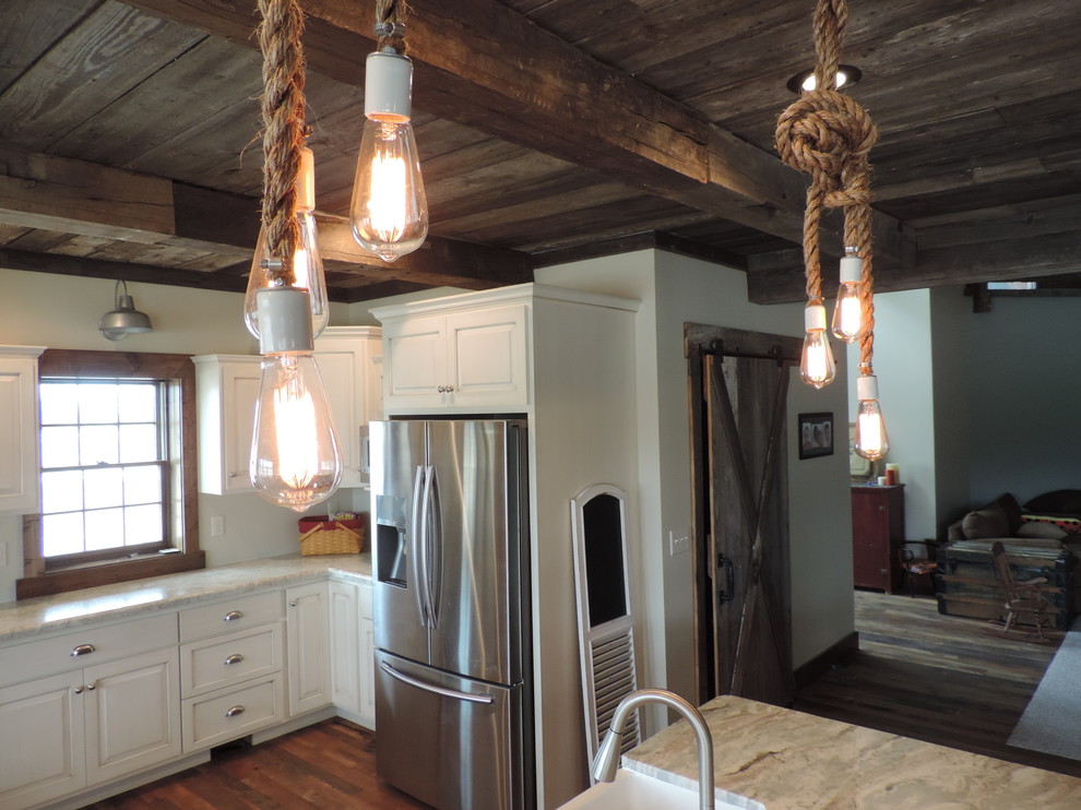 Inspiration for a large rustic u-shaped dark wood floor eat-in kitchen remodel with a farmhouse sink, raised-panel cabinets, white cabinets, marble countertops, stainless steel appliances and an island
