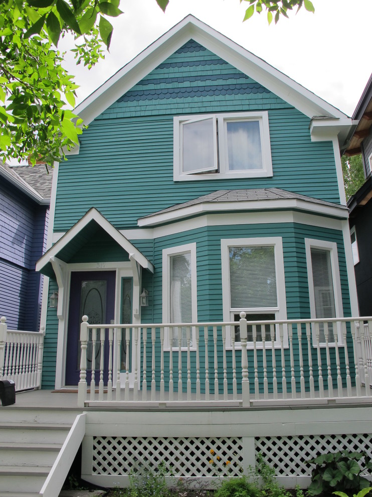 Mid-sized traditional two-storey green exterior in Calgary with wood siding.