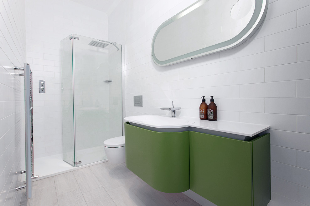 Photo of a contemporary bathroom in Hampshire with an alcove shower, white tile, subway tile and green cabinets.