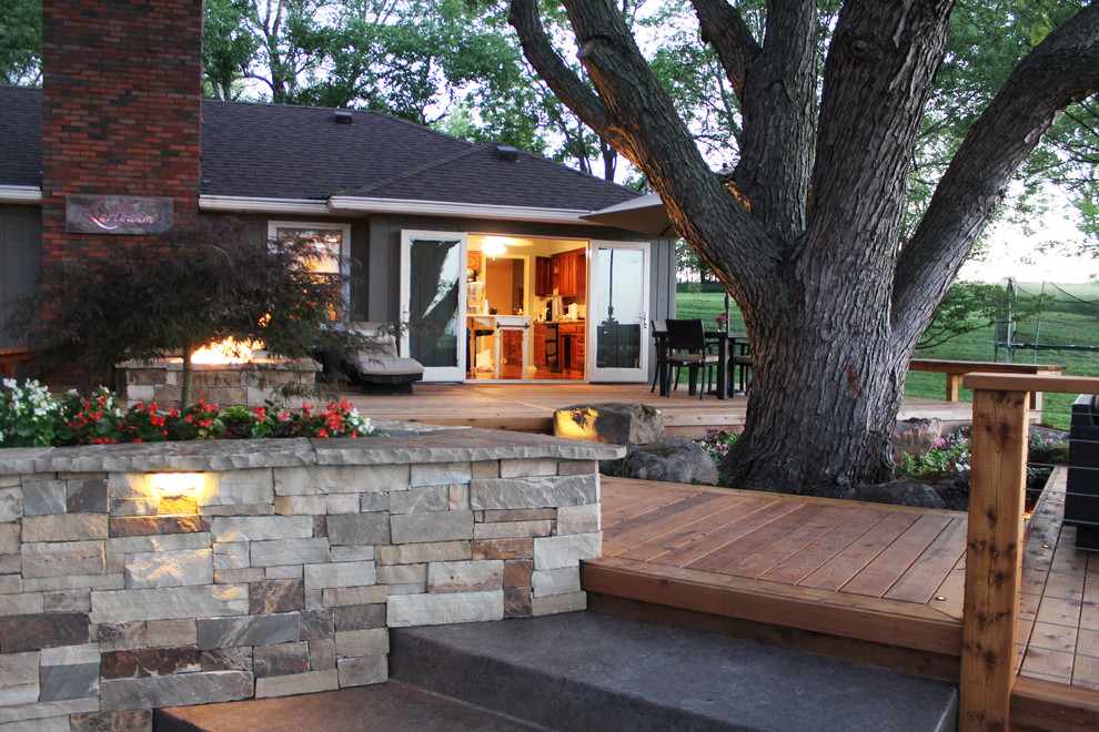 Deck - large contemporary backyard deck idea in Kansas City with a fire pit and no cover