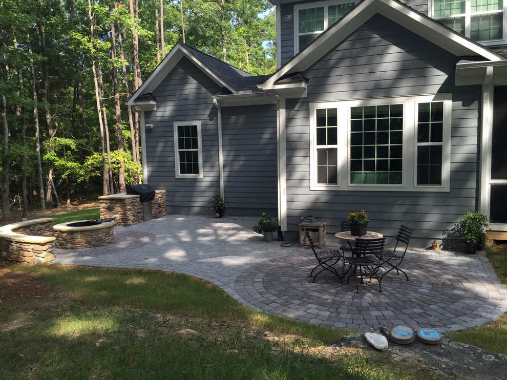 Photo of a mid-sized traditional backyard patio in Raleigh with an outdoor kitchen, concrete pavers and no cover.