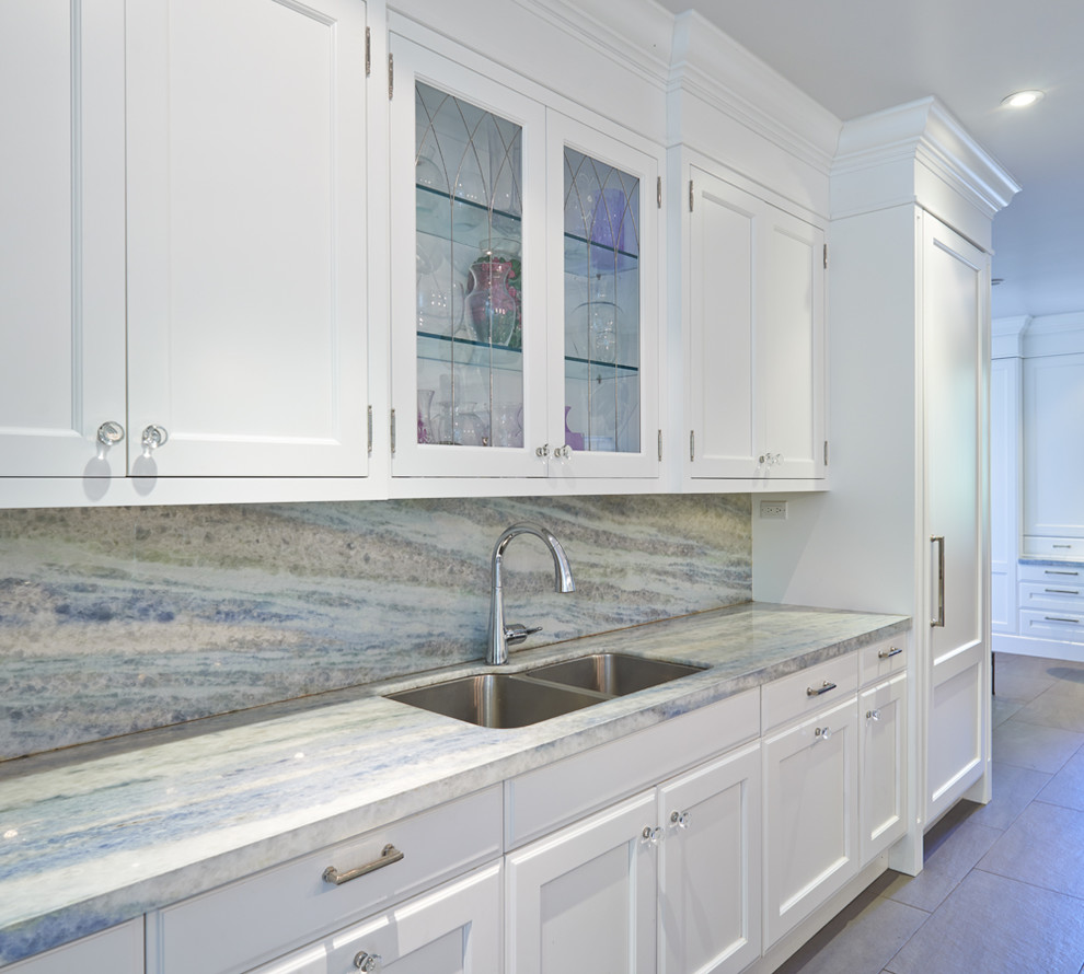 Inspiration for a large transitional l-shaped medium tone wood floor open concept kitchen remodel in Toronto with an undermount sink, shaker cabinets, white cabinets, quartz countertops, multicolored backsplash, stone slab backsplash, stainless steel appliances and an island