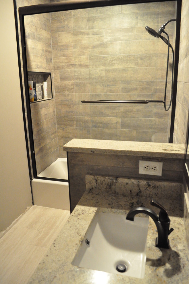 Design ideas for a small industrial kids bathroom in Atlanta with shaker cabinets, dark wood cabinets, an undermount tub, a shower/bathtub combo, a two-piece toilet, brown tile, ceramic tile, ceramic floors, an undermount sink and granite benchtops.