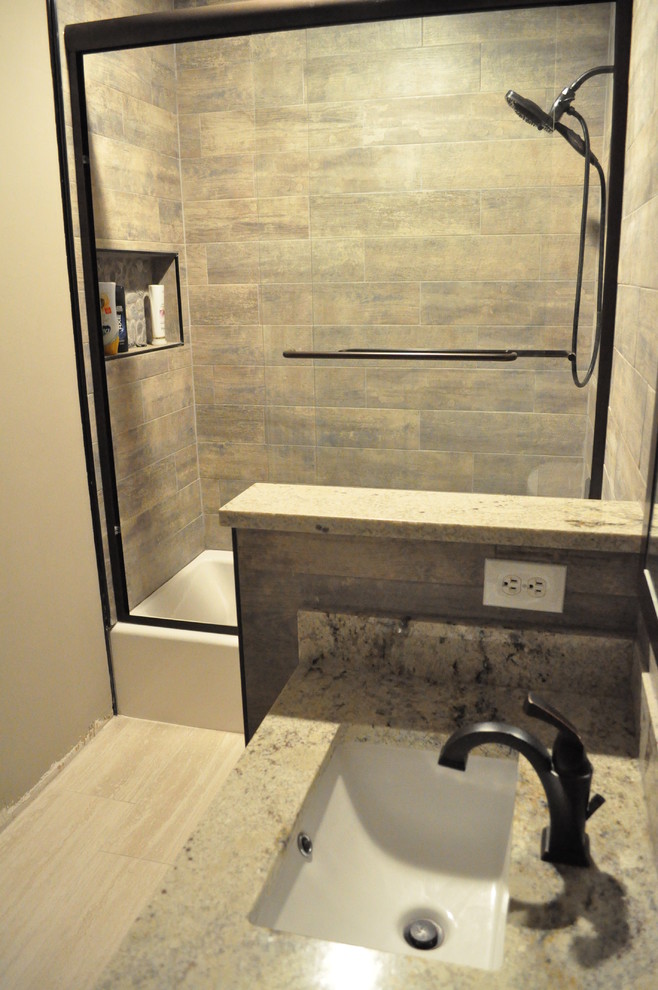 Small urban kids' brown tile and ceramic tile ceramic tile tub/shower combo photo in Atlanta with shaker cabinets, dark wood cabinets, an undermount tub, a two-piece toilet, an undermount sink and granite countertops