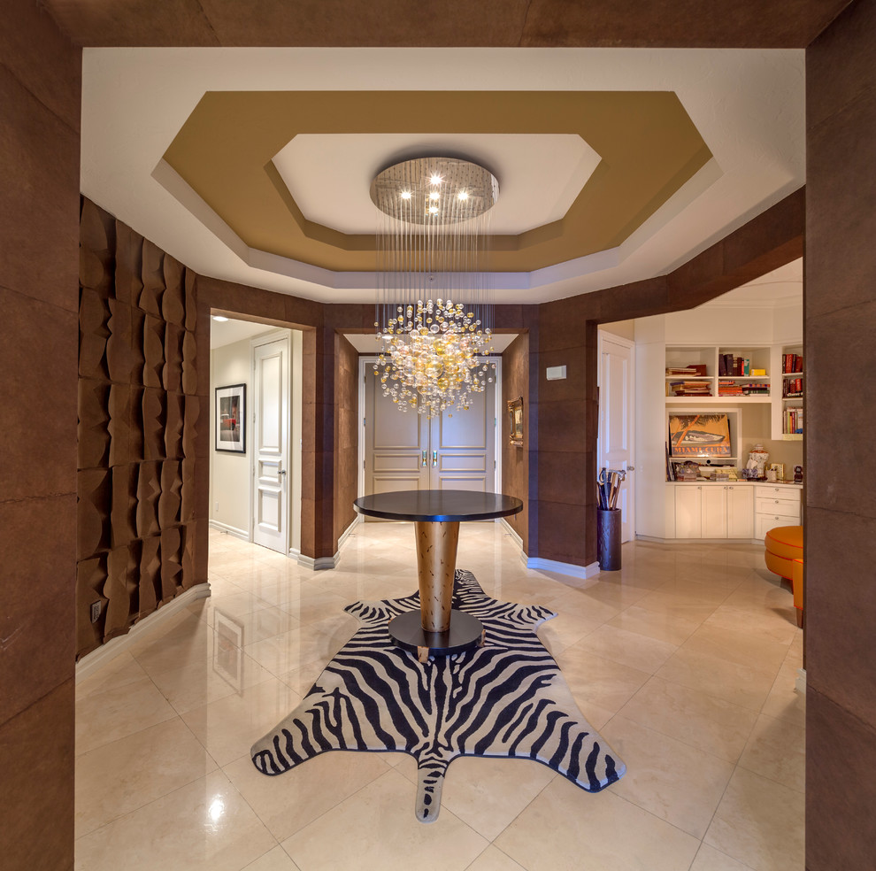 This is an example of a large contemporary entry hall in Los Angeles with brown walls, travertine floors, a double front door and a gray front door.