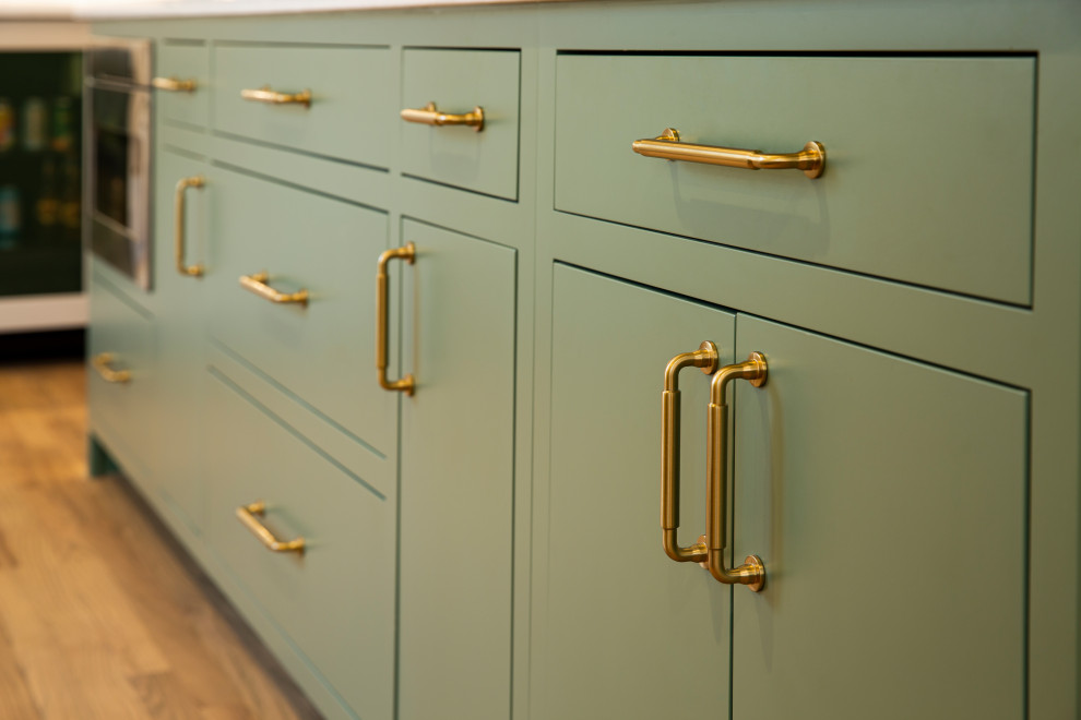 Inspiration for a mid-sized transitional l-shaped medium tone wood floor eat-in kitchen remodel in Cincinnati with an undermount sink, beige cabinets, quartz countertops, marble backsplash, stainless steel appliances, an island and white countertops