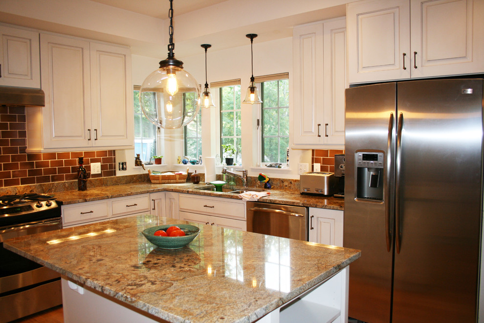 Eat-in kitchen - mid-sized transitional u-shaped medium tone wood floor and brown floor eat-in kitchen idea with raised-panel cabinets, white cabinets, granite countertops, brown backsplash, subway tile backsplash, stainless steel appliances, an island and a double-bowl sink