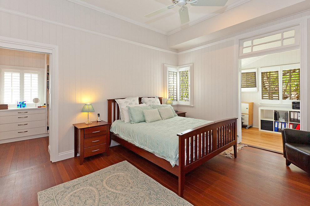 Photo of a large traditional master bedroom in Brisbane with white walls, medium hardwood floors and no fireplace.