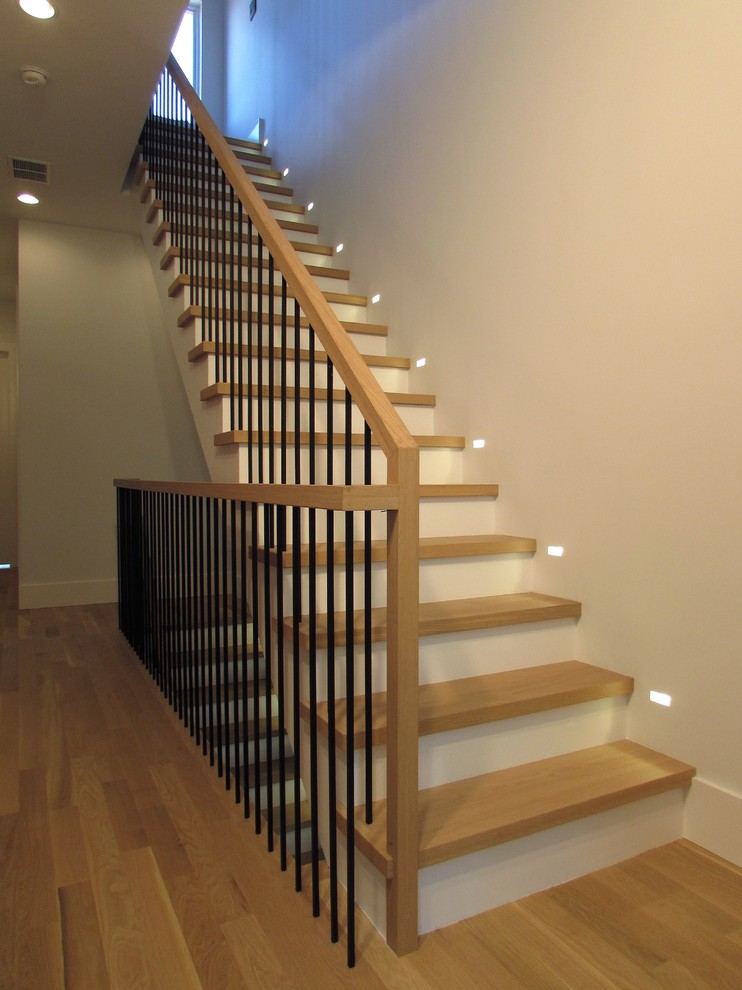 Design ideas for a large contemporary wood l-shaped staircase in Chicago with wood risers and metal railing.