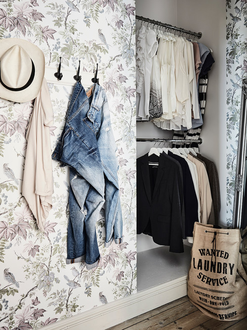 floral wall with hanging clothes