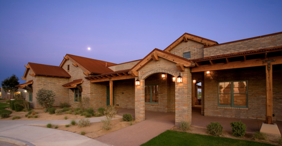 Design ideas for a large one-storey brick brown exterior in Phoenix with a flat roof.