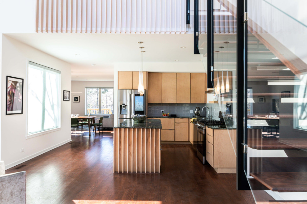 Contemporary l-shaped kitchen in Chicago with an undermount sink, flat-panel cabinets, light wood cabinets, marble benchtops, blue splashback, porcelain splashback, stainless steel appliances, dark hardwood floors, with island, brown floor and green benchtop.