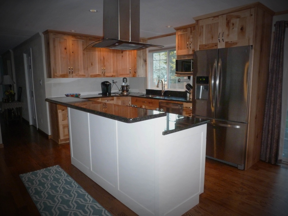 Large mountain style u-shaped medium tone wood floor and brown floor eat-in kitchen photo in Seattle with a double-bowl sink, shaker cabinets, light wood cabinets, granite countertops, stainless steel appliances and an island