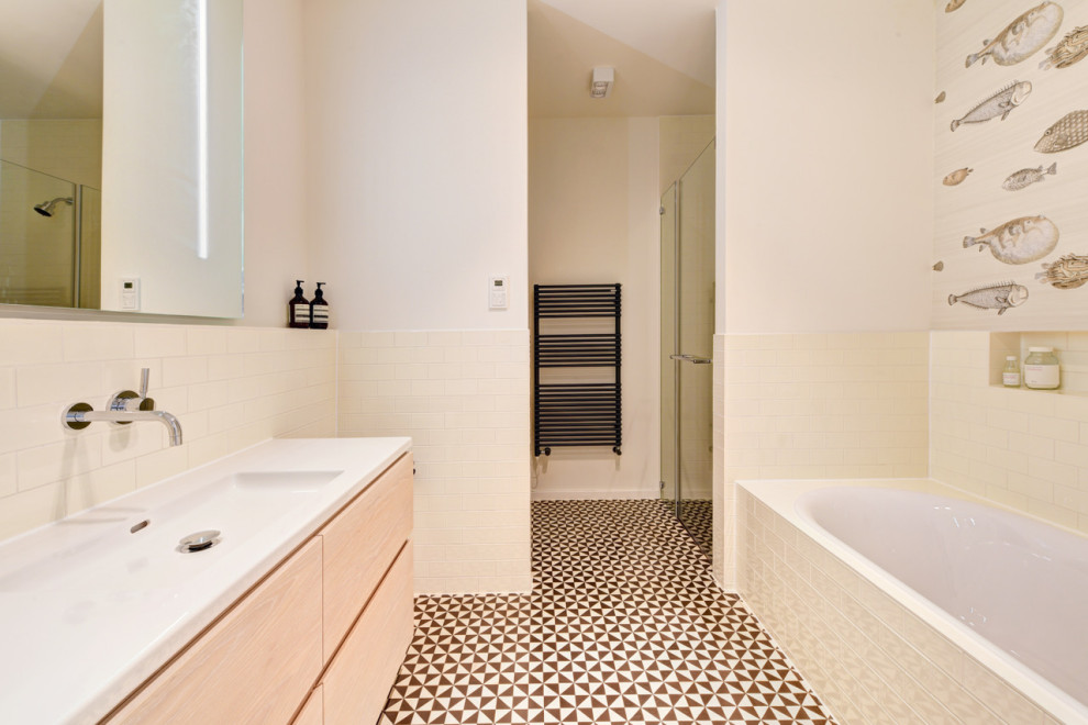Example of a mid-sized minimalist kids' beige tile and ceramic tile cement tile floor, black floor, single-sink and wallpaper bathroom design in Munich with furniture-like cabinets, white cabinets, a wall-mount toilet, beige walls, beige countertops and a built-in vanity