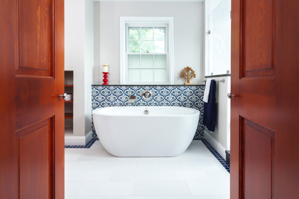 Inspiration for a large transitional master bathroom in DC Metro with shaker cabinets, medium wood cabinets, a freestanding tub, a double shower, a one-piece toilet, multi-coloured tile, porcelain tile, grey walls, marble floors, an undermount sink, granite benchtops, white floor and a hinged shower door.