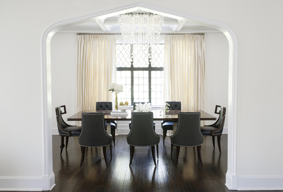 Contemporary dining room in New York with white walls and dark hardwood floors.