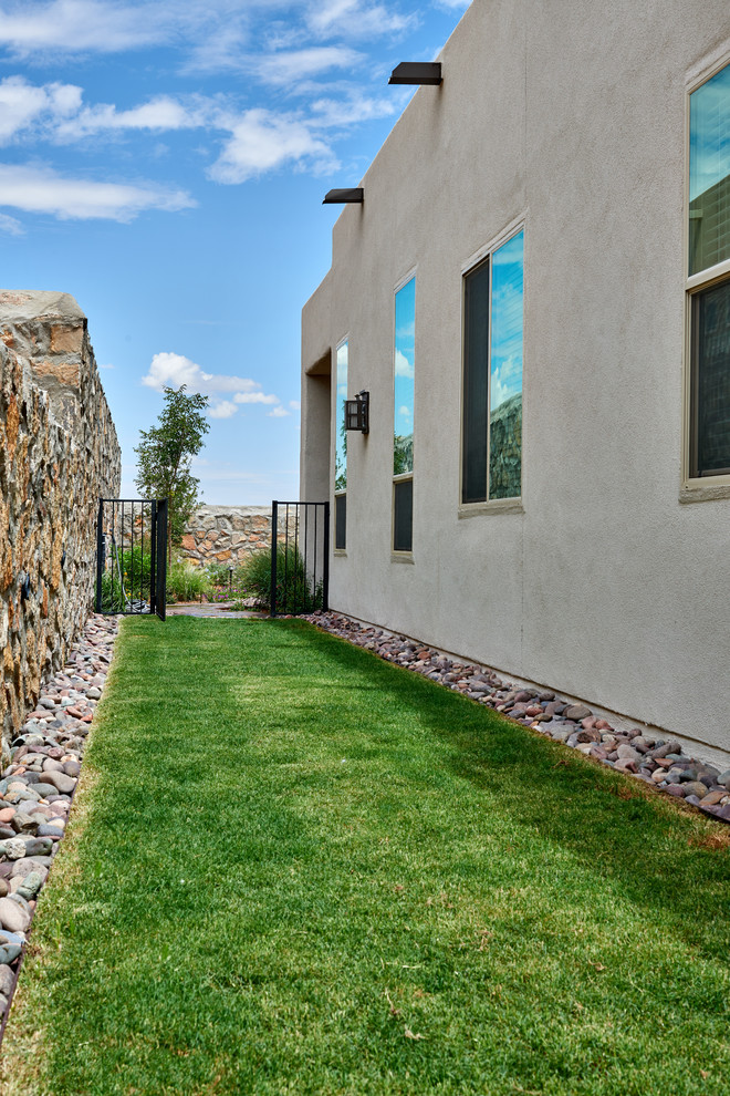 This is an example of a transitional backyard xeriscape in Other with a garden path and gravel.