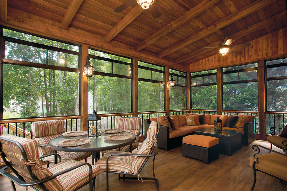 Inspiration for a large transitional backyard screened-in verandah in Atlanta with decking and a roof extension.