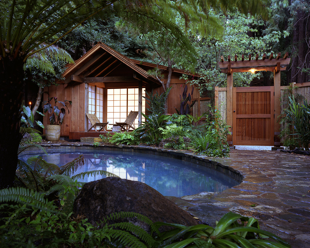 Design ideas for an asian round pool in San Francisco with natural stone pavers.