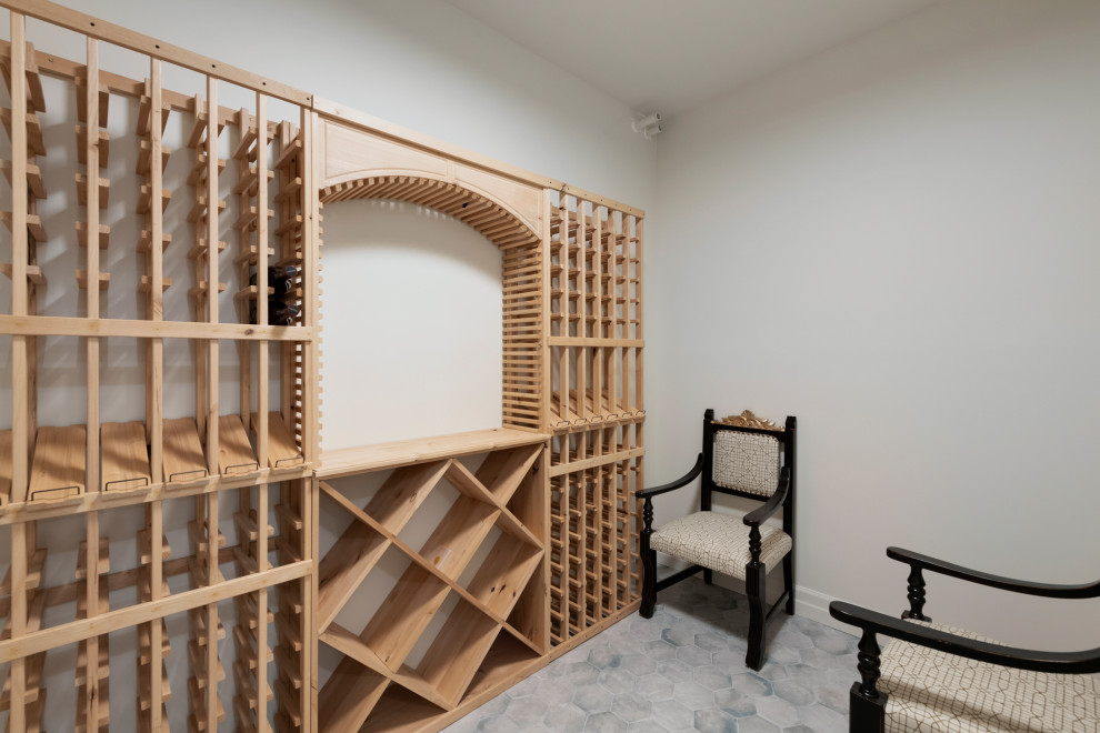 Example of a mid-sized arts and crafts ceramic tile and gray floor wine cellar design in Minneapolis with display racks