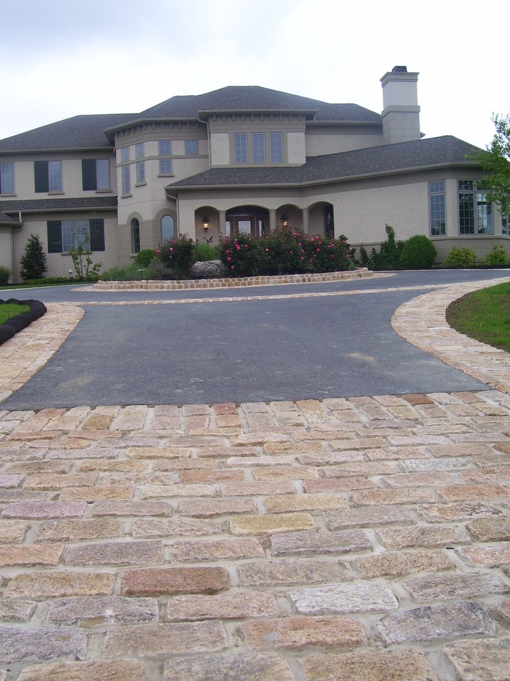 This is an example of a large traditional driveway in Philadelphia with natural stone pavers.