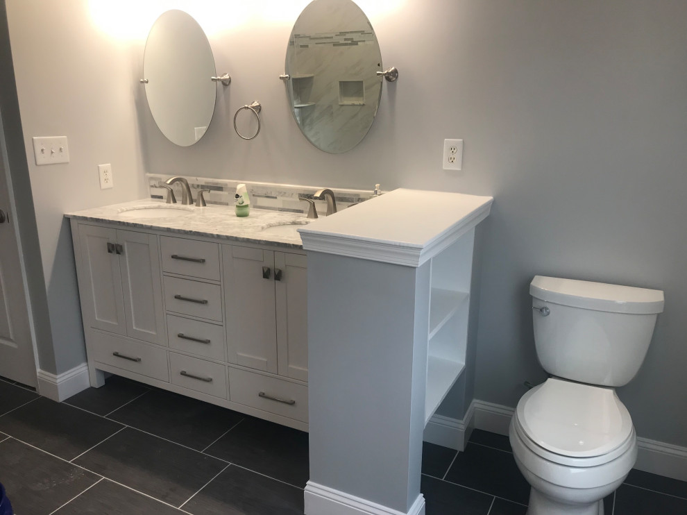 This is an example of a small modern 3/4 bathroom in DC Metro with recessed-panel cabinets, white cabinets, an alcove shower, a two-piece toilet, multi-coloured tile, porcelain tile, grey walls, quartzite benchtops, grey floor, an open shower, white benchtops, a double vanity and a freestanding vanity.