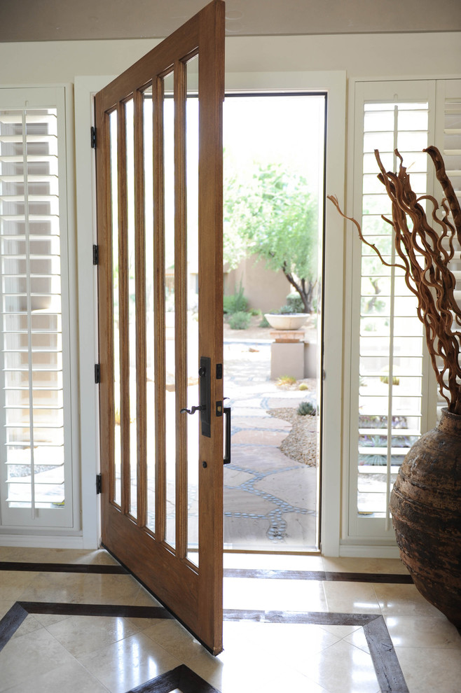 Photo of a large traditional front door in Phoenix with beige walls, porcelain floors, a single front door, a light wood front door and beige floor.